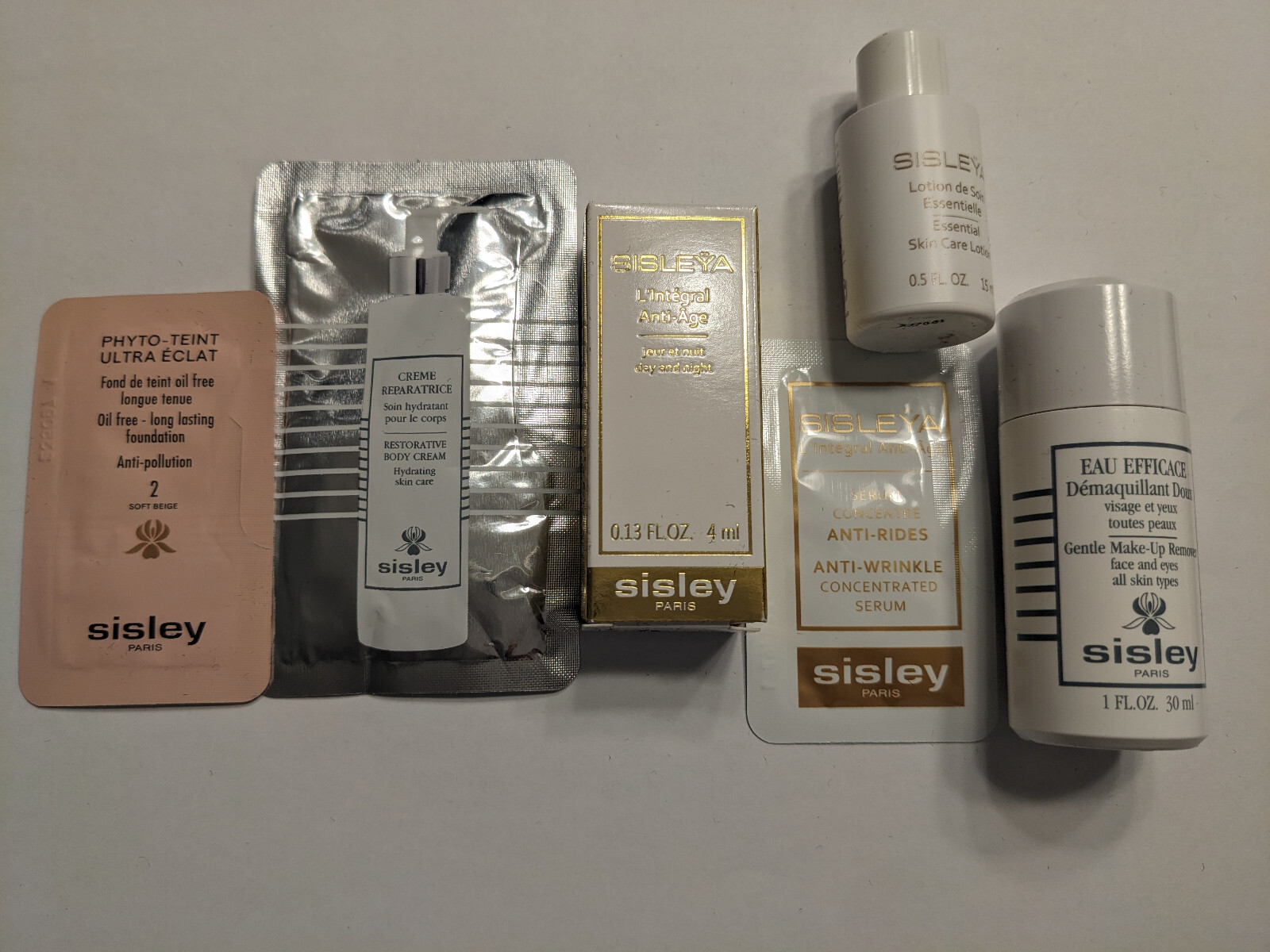 QTY 9 Sisley sample set, L’Integral Anti-age , serum & Winter 2025 make up bag