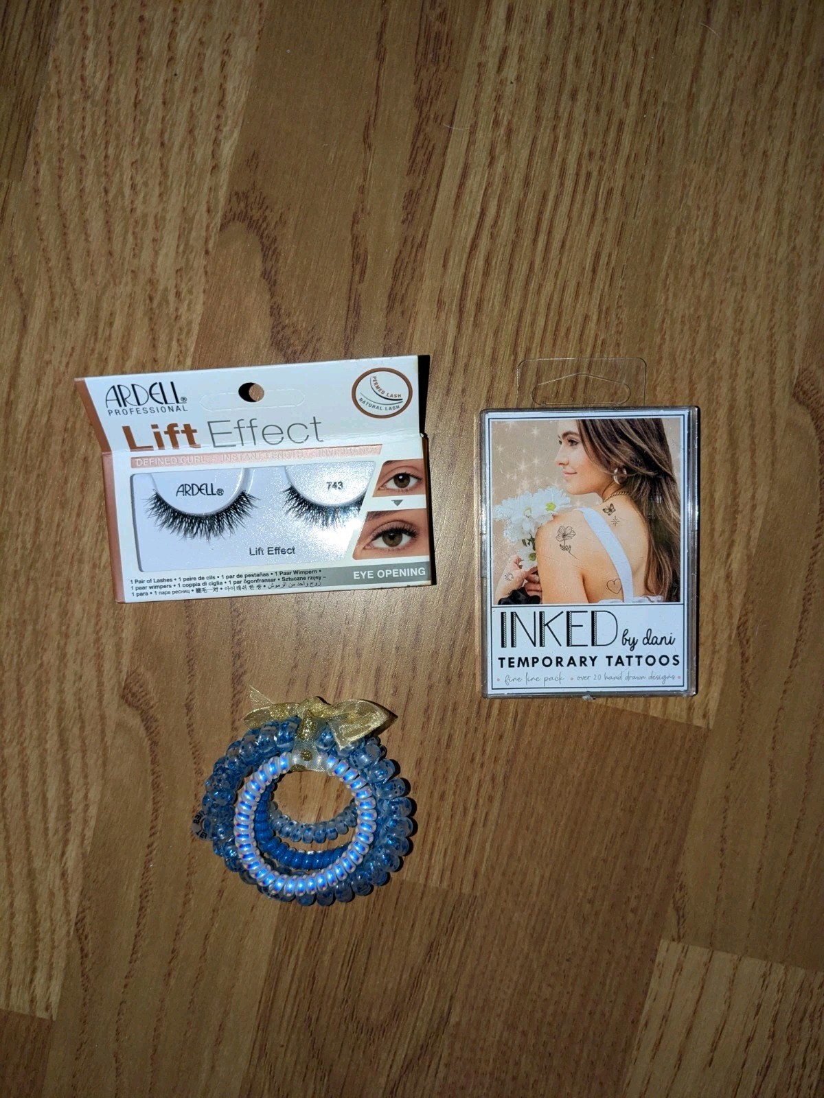 bundle of beauty items: false eyelashes, hair ties, temporary tattoos